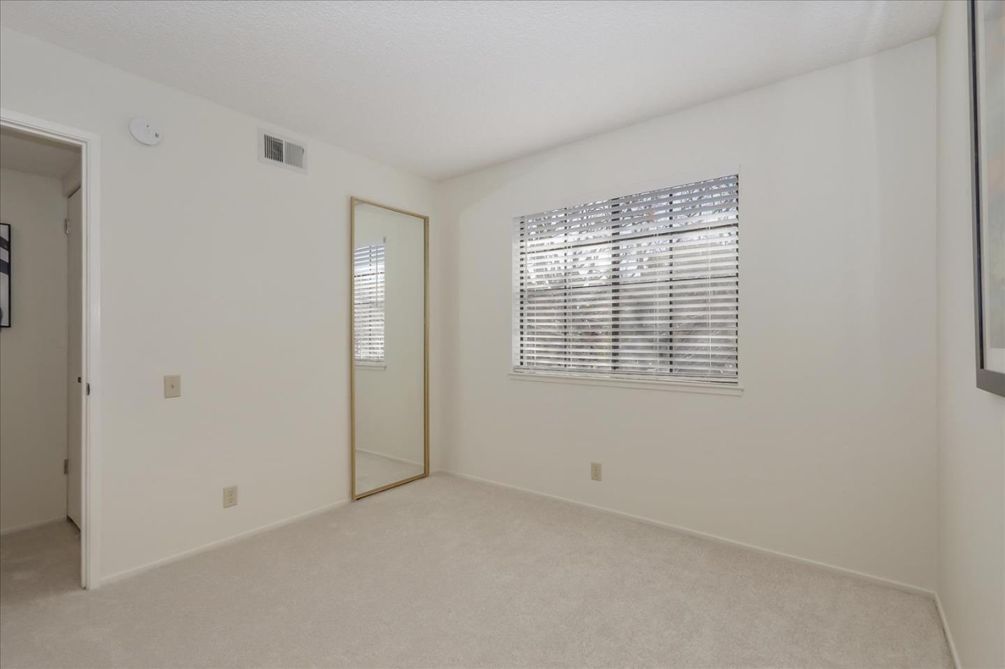 430 Costa Mesa Terrace, Unit E Sunnyvale, CA 94085 - Photo 18 of 40 an empty room with windows