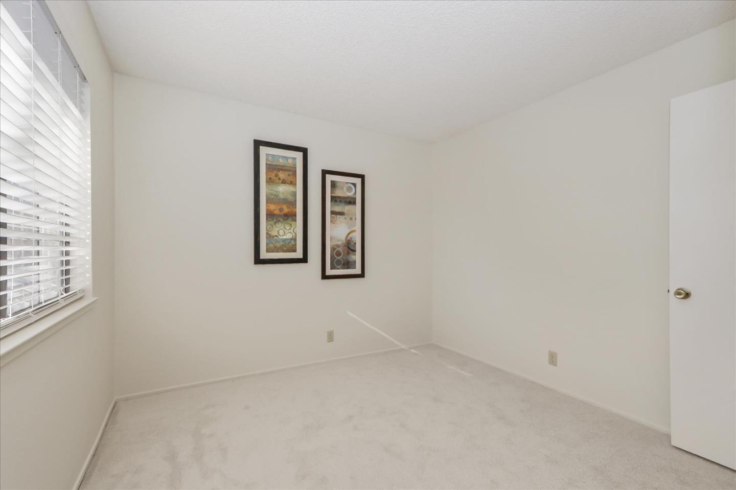430 Costa Mesa Terrace, Unit E Sunnyvale, CA 94085 - Photo 19 of 40 an empty room with windows