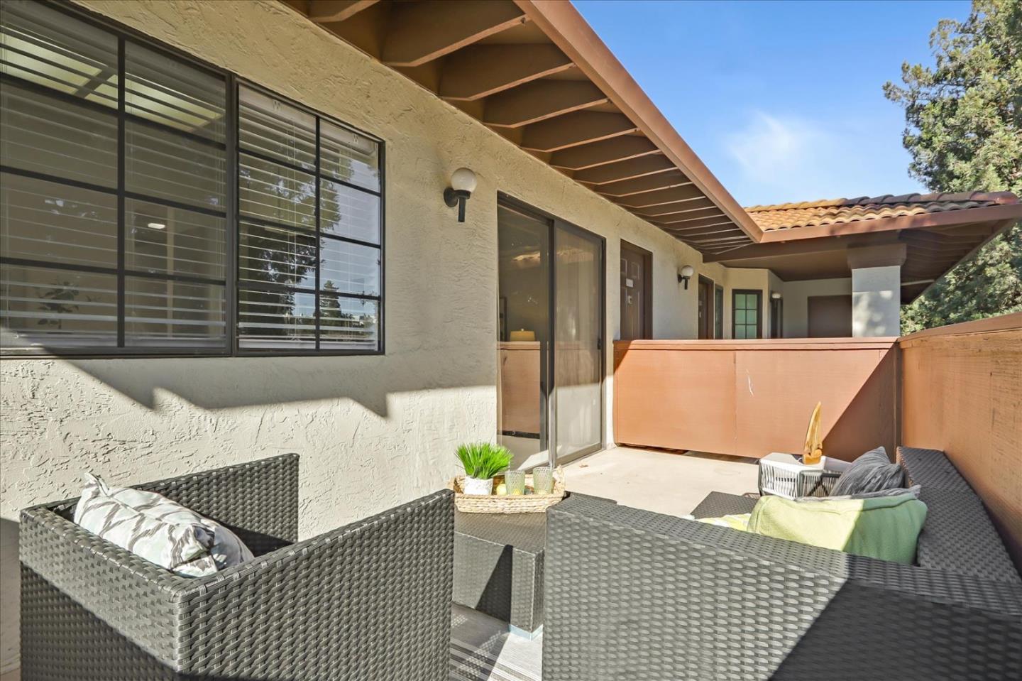 430 Costa Mesa Terrace, Unit E Sunnyvale, CA 94085 - Photo 24 of 40 a view of a patio with couches table and chairs and potted plants
