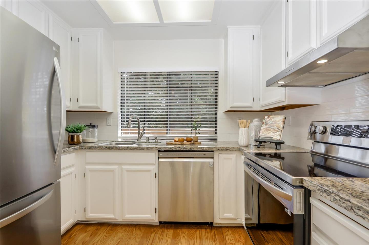 430 Costa Mesa Terrace, Unit E Sunnyvale, CA 94085 - Photo 9 of 40 a kitchen with stainless steel appliances granite countertop a sink stove and refrigerator
