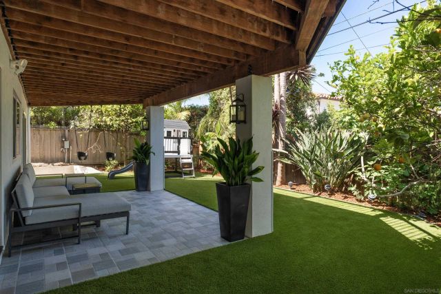 a view of a porch with furniture and a yard
