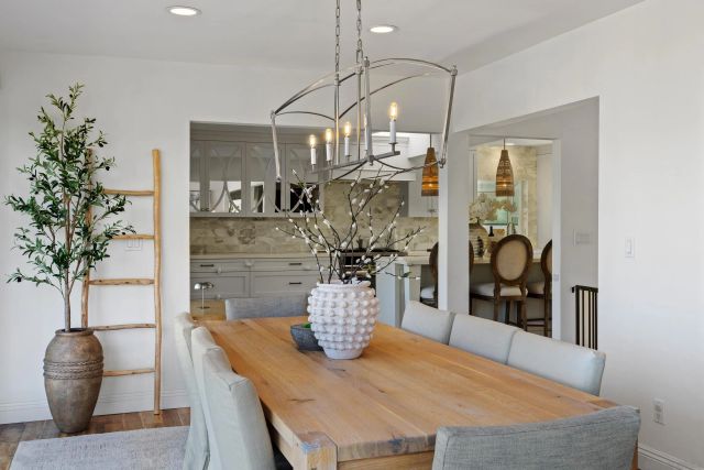 a view of a dining room with furniture and chandelier