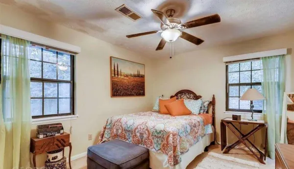 a bedroom with a bed and window