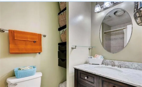 a bathroom with a granite countertop sink and a mirror