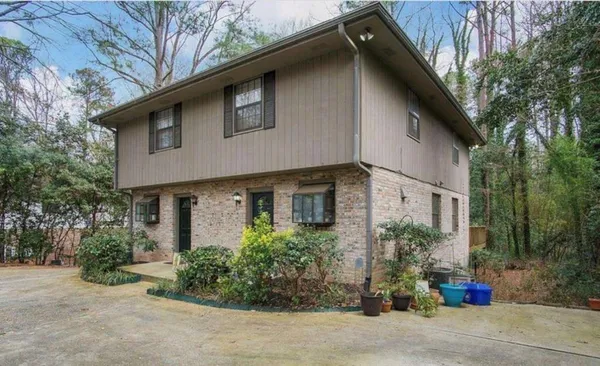 a front view of a house with garden