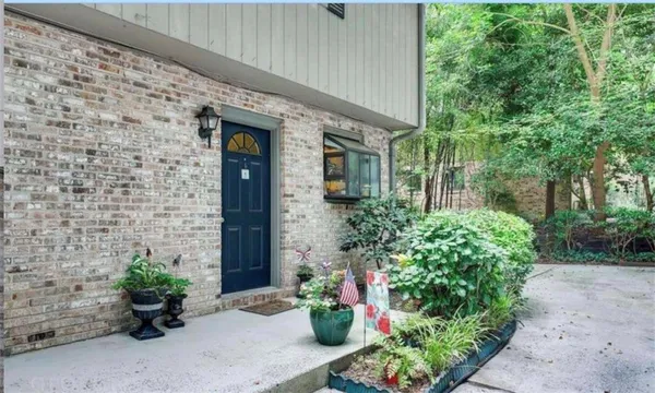 a front view of a house with a garden
