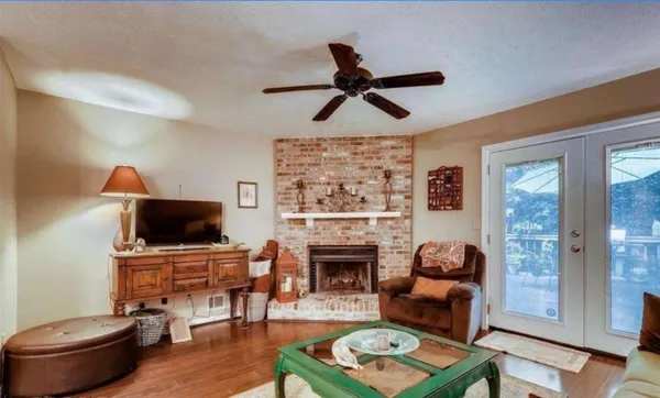 a living room with furniture a fireplace and a flat screen tv