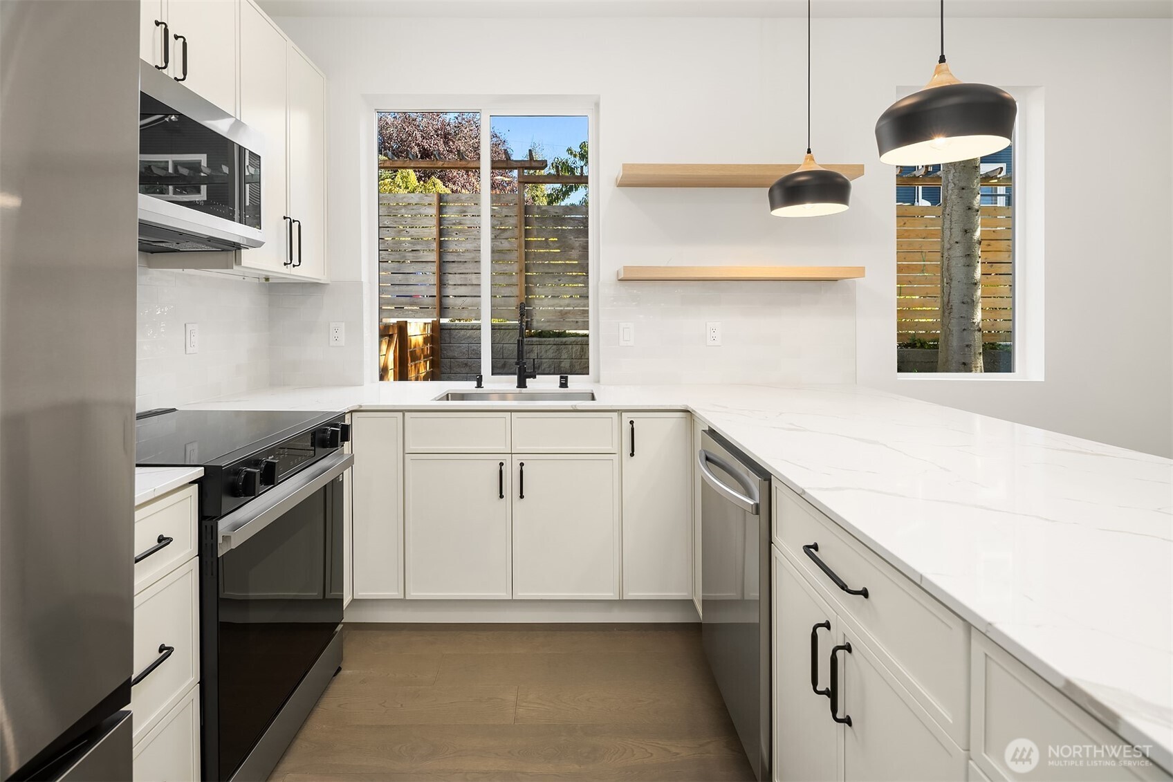 3444 Northwest 65th Street Seattle, WA 98117 - Photo 12 of 38 a kitchen with a sink stove and microwave