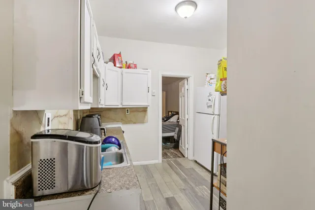a kitchen with a refrigerator and a sink