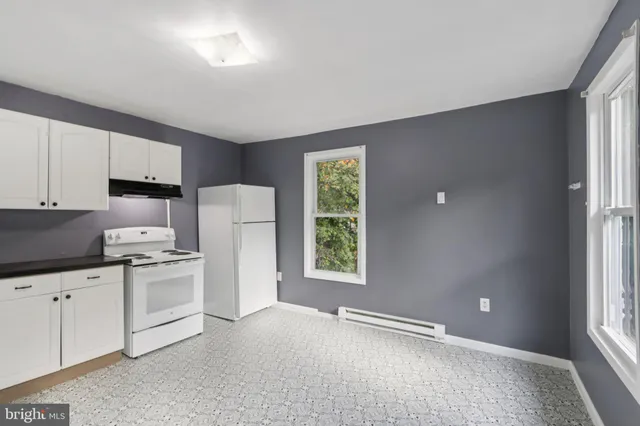 a kitchen with a refrigerator a stove a microwave and cabinets