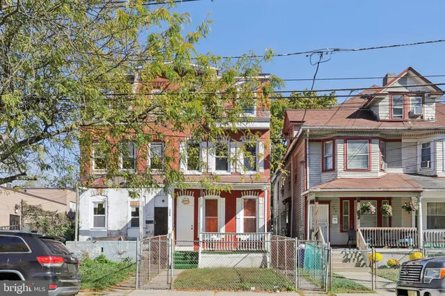 a front view of a residential apartment building with a yard
