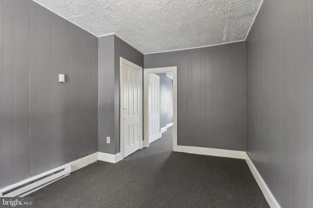 a bedroom with bed and dresser