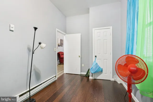 a bedroom with a bed and large windows