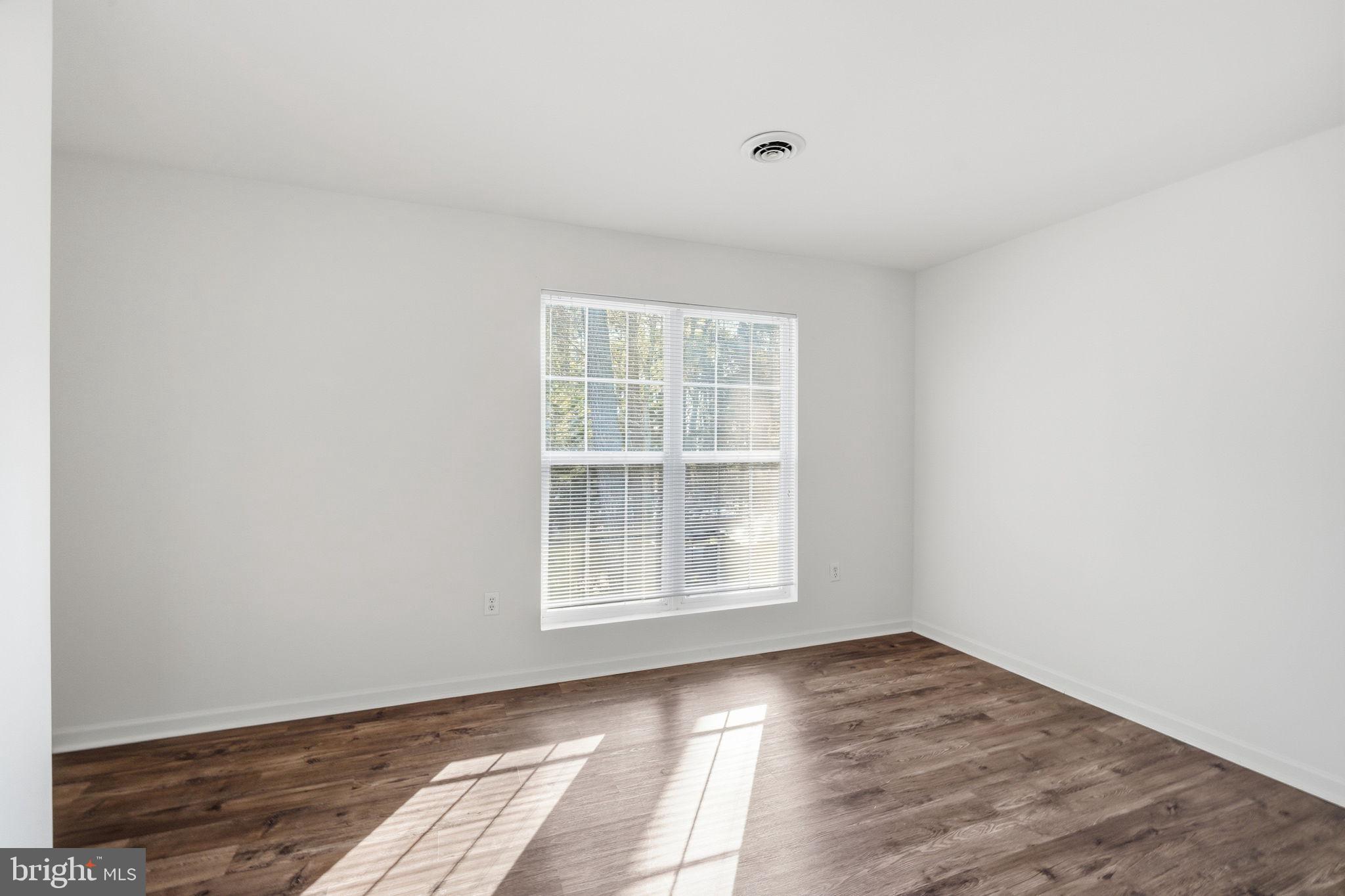 21103 Striper Run Rock Hall, MD 21661 - Photo 10 of 20 an empty room with wooden floor and windows