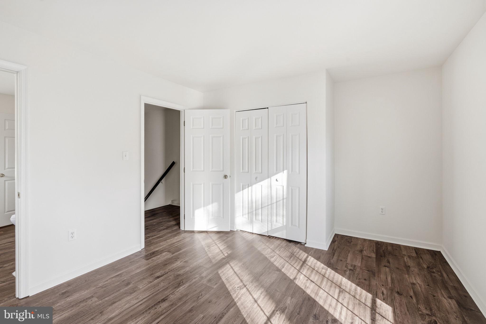 21103 Striper Run Rock Hall, MD 21661 - Photo 11 of 20 a view of a room with wooden floor and white walls