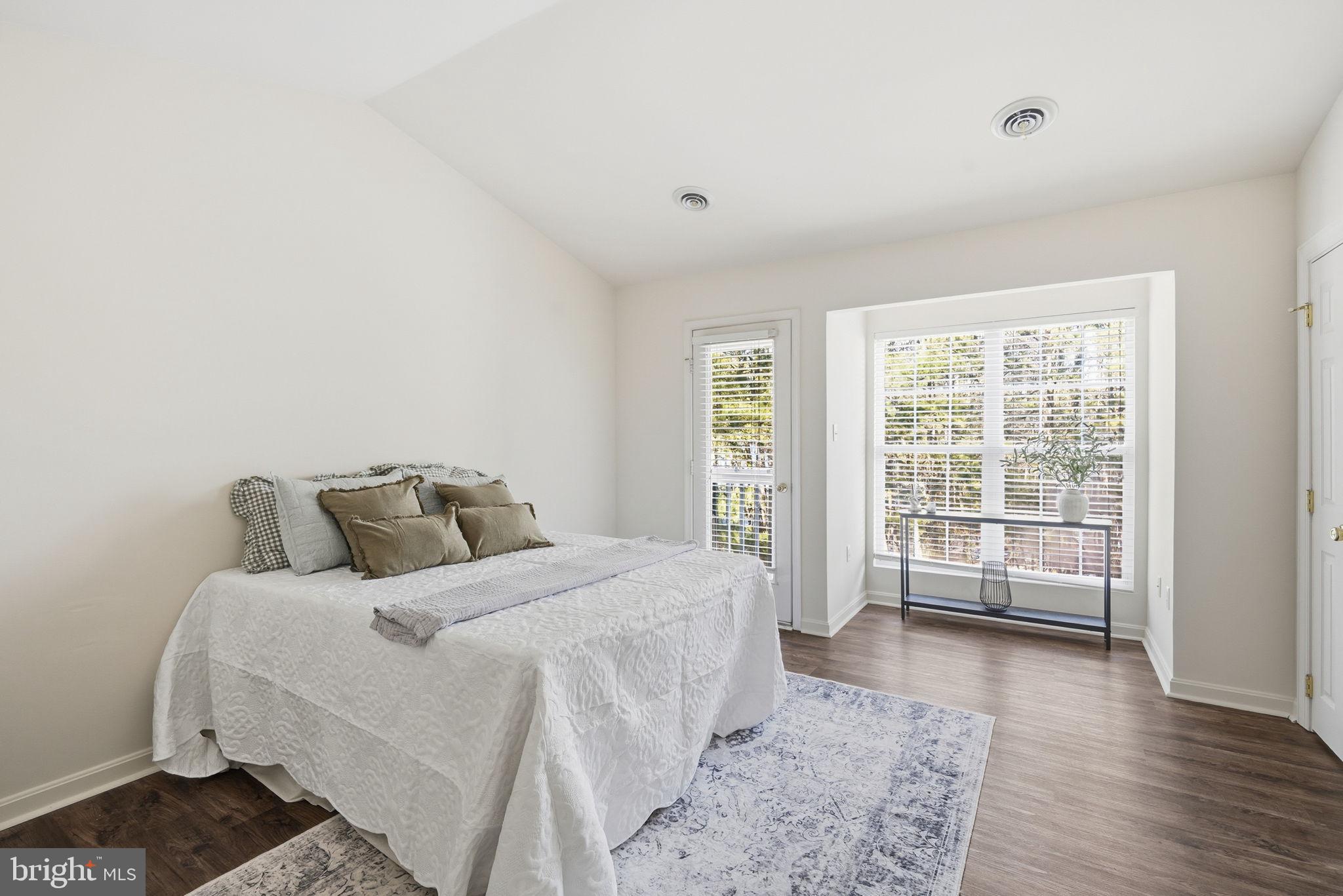 21103 Striper Run Rock Hall, MD 21661 - Photo 7 of 20 a bedroom with a bed and wooden floor