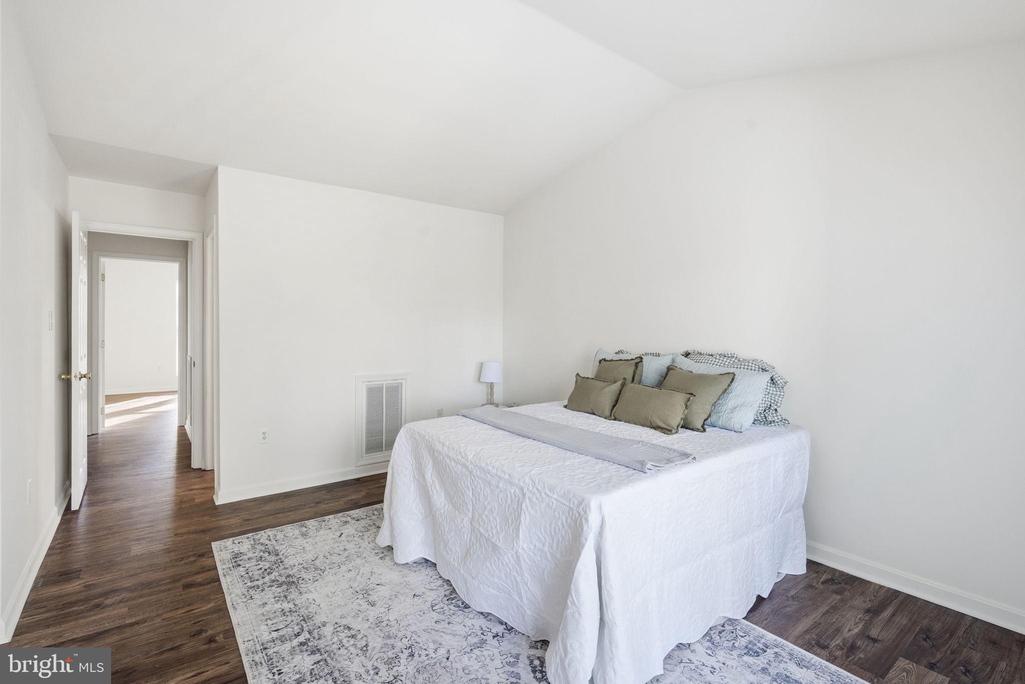 21103 Striper Run Rock Hall, MD 21661 - Photo 8 of 20 a bedroom with a bed and wooden floor