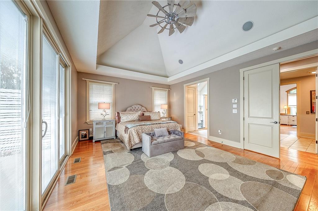 815 Mt Pleasant Road Mars, PA 16046 - Photo 19 of 42 First floor primary suite has vaulted ceiling, hardwood floors, sliding door to added deck and built-in hot tub. The primary closet offers built-ins