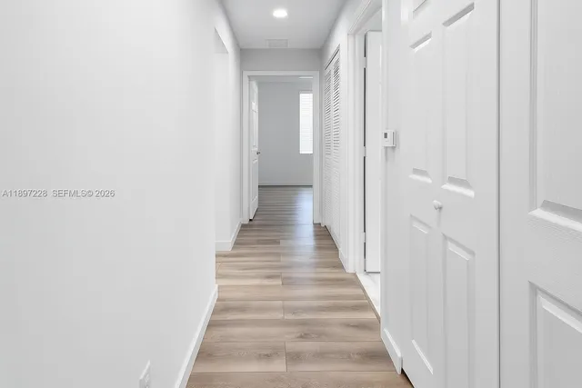 a view of a bathroom with wooden floor