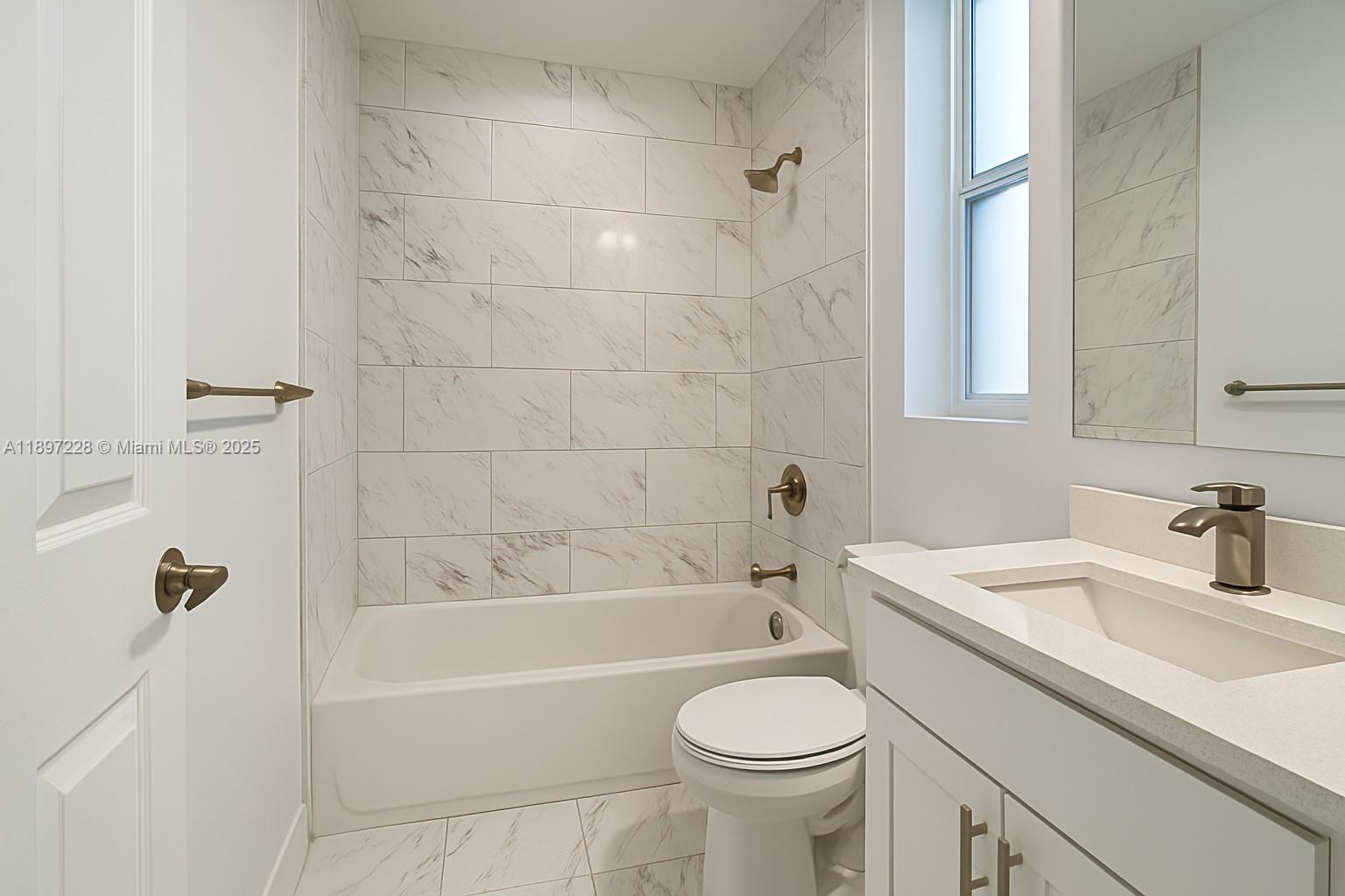 432 21st Street, Unit 432 West Palm Beach, FL 33407 - Photo 12 of 14 a bathroom with a sink a toilet and a bathtub