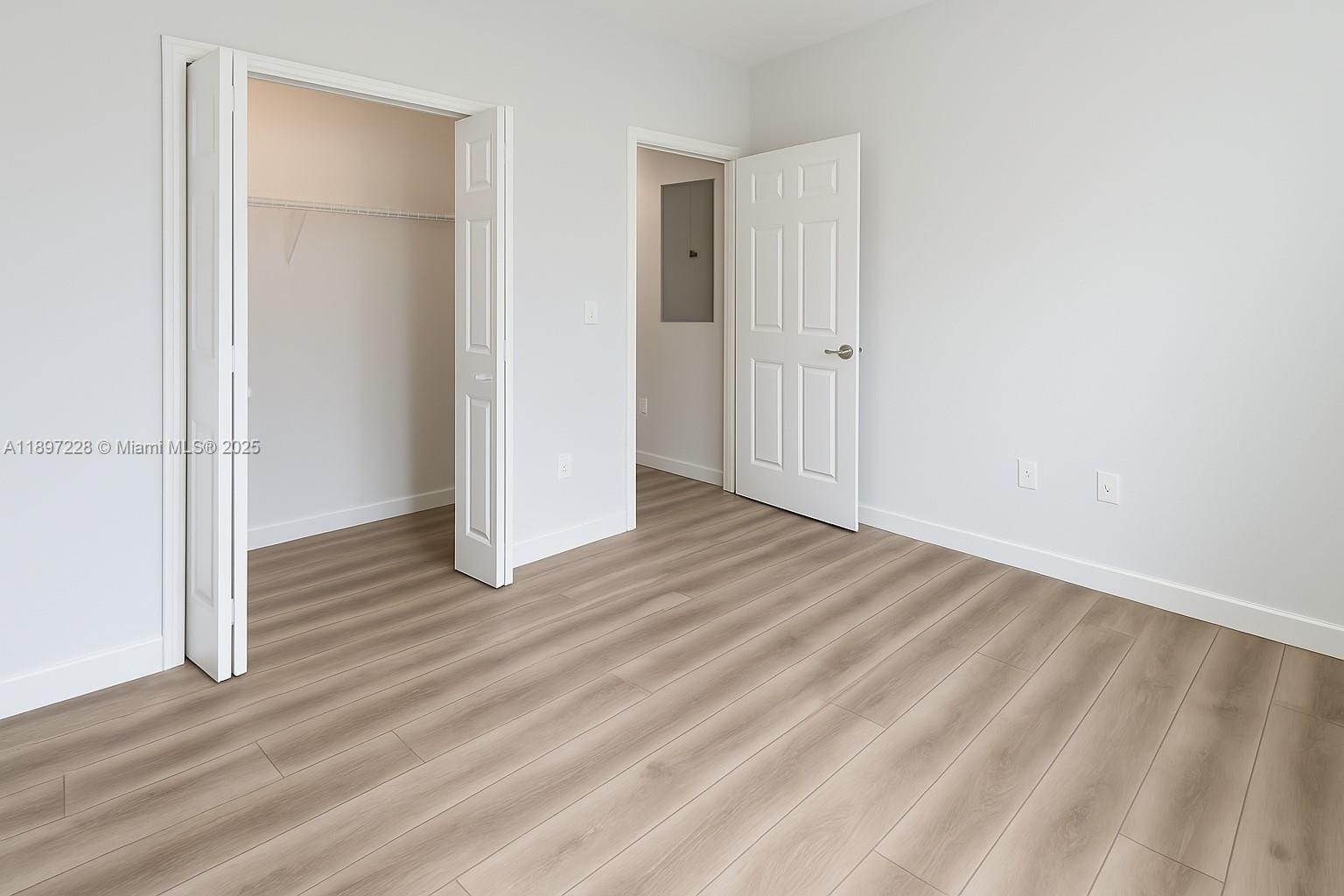 432 21st Street, Unit 432 West Palm Beach, FL 33407 - Photo 6 of 14 an empty room with wooden floor and closet