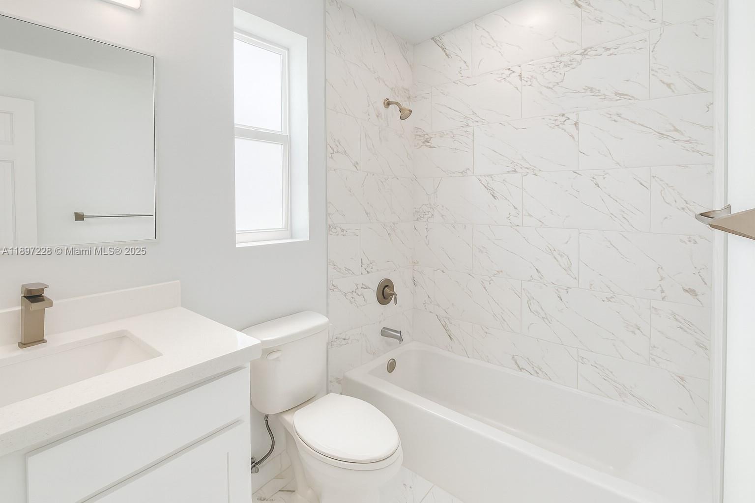 432 21st Street, Unit 432 West Palm Beach, FL 33407 - Photo 7 of 14 a bathroom with a sink a toilet and a bathtub