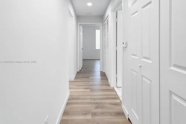 a view of a bathroom with wooden floor