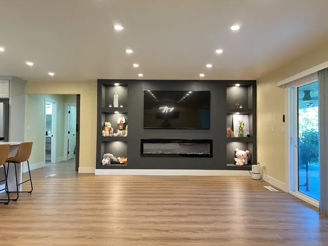a view of a living room with hardwood floor and a flat screen tv