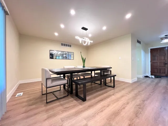 a view of a room with furniture and wooden floor
