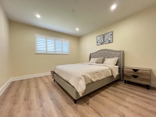 a bedroom with a bed and a couch