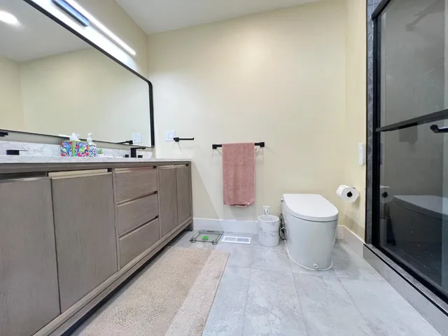 a bathroom with a sink a toilet and mirror