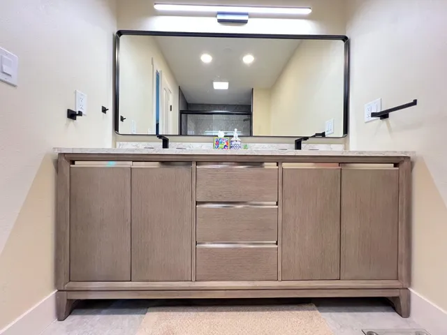 a bathroom with a sink vanity and mirror