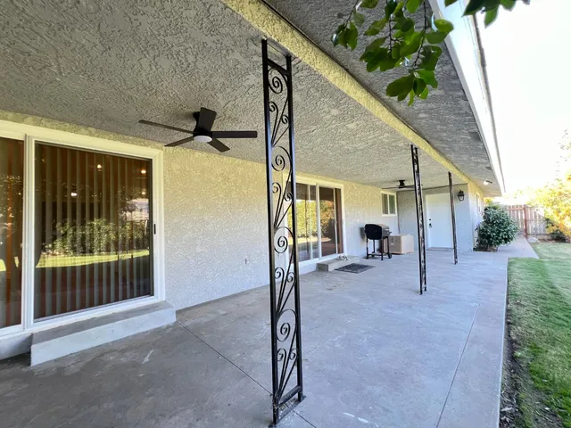 a view of a house with backyard and porch