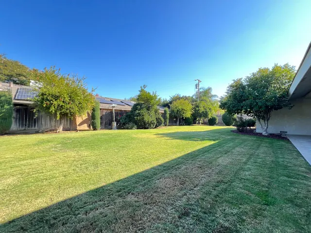 a view of outdoor space with garden and trees