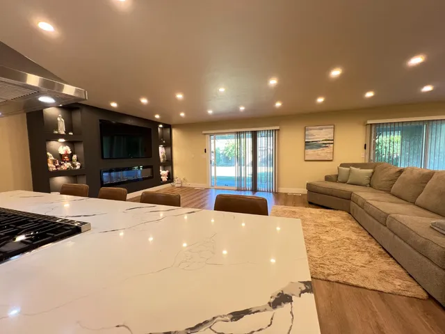 a large living room with furniture and a flat screen tv