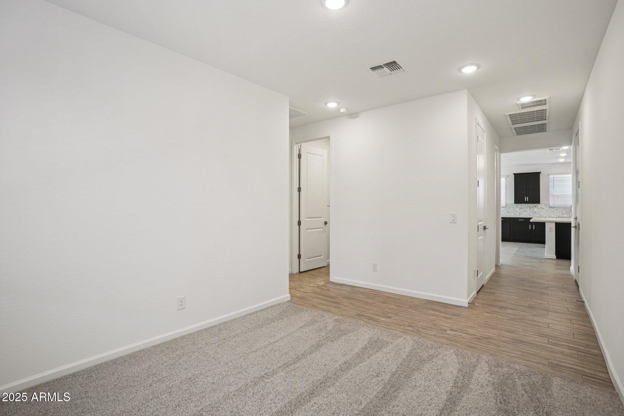 15723 West Brown Street Waddell, AZ 85355 - Photo 11 of 51 a view of a hallway with wooden floor and a kitchen