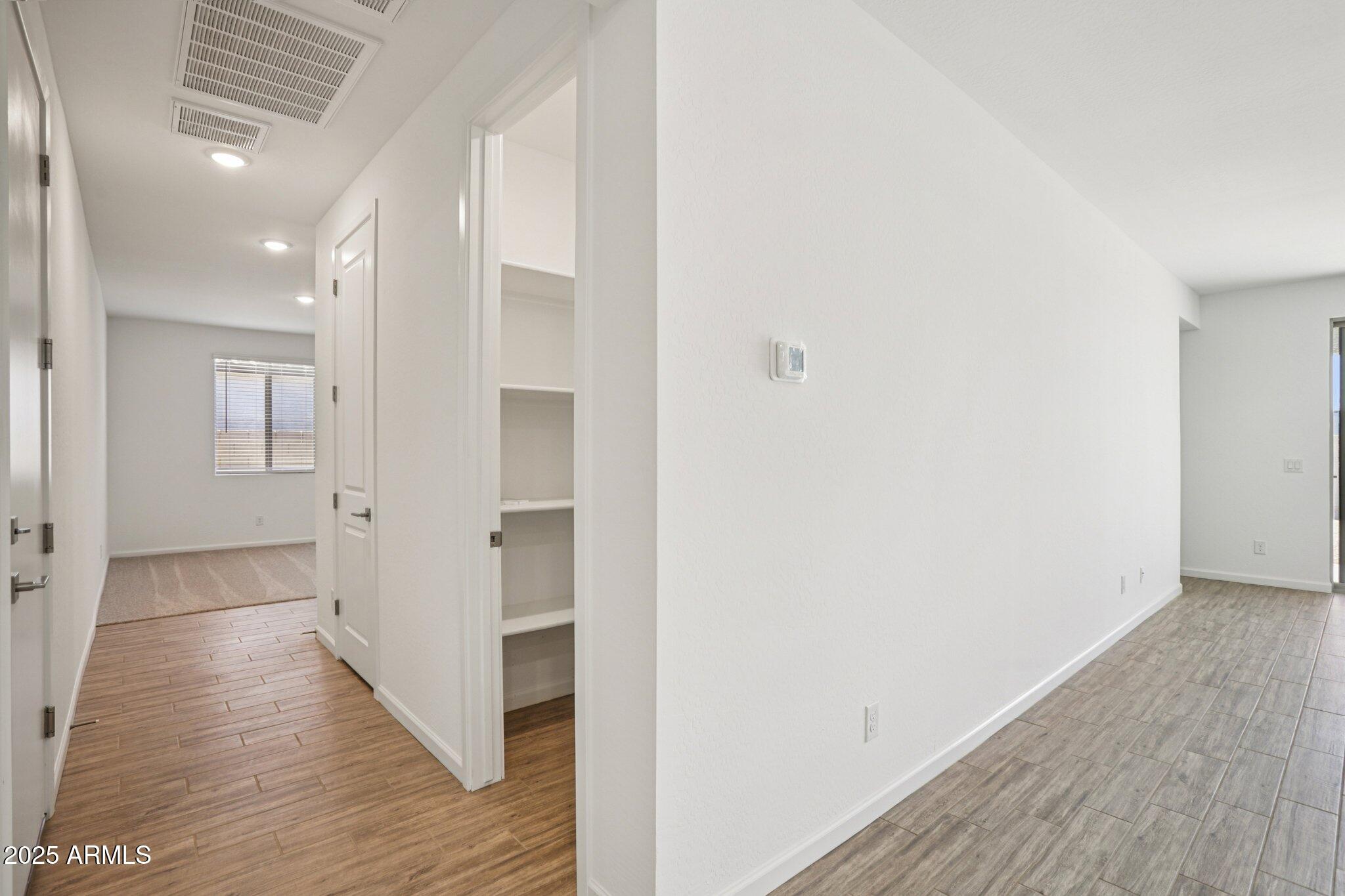 15723 West Brown Street Waddell, AZ 85355 - Photo 12 of 51 a view of a hallway with wooden floor