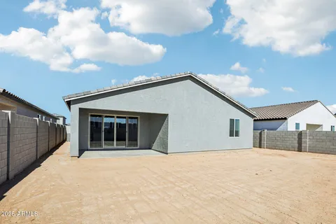 a view of a swimming pool with a chairs and table in the patio