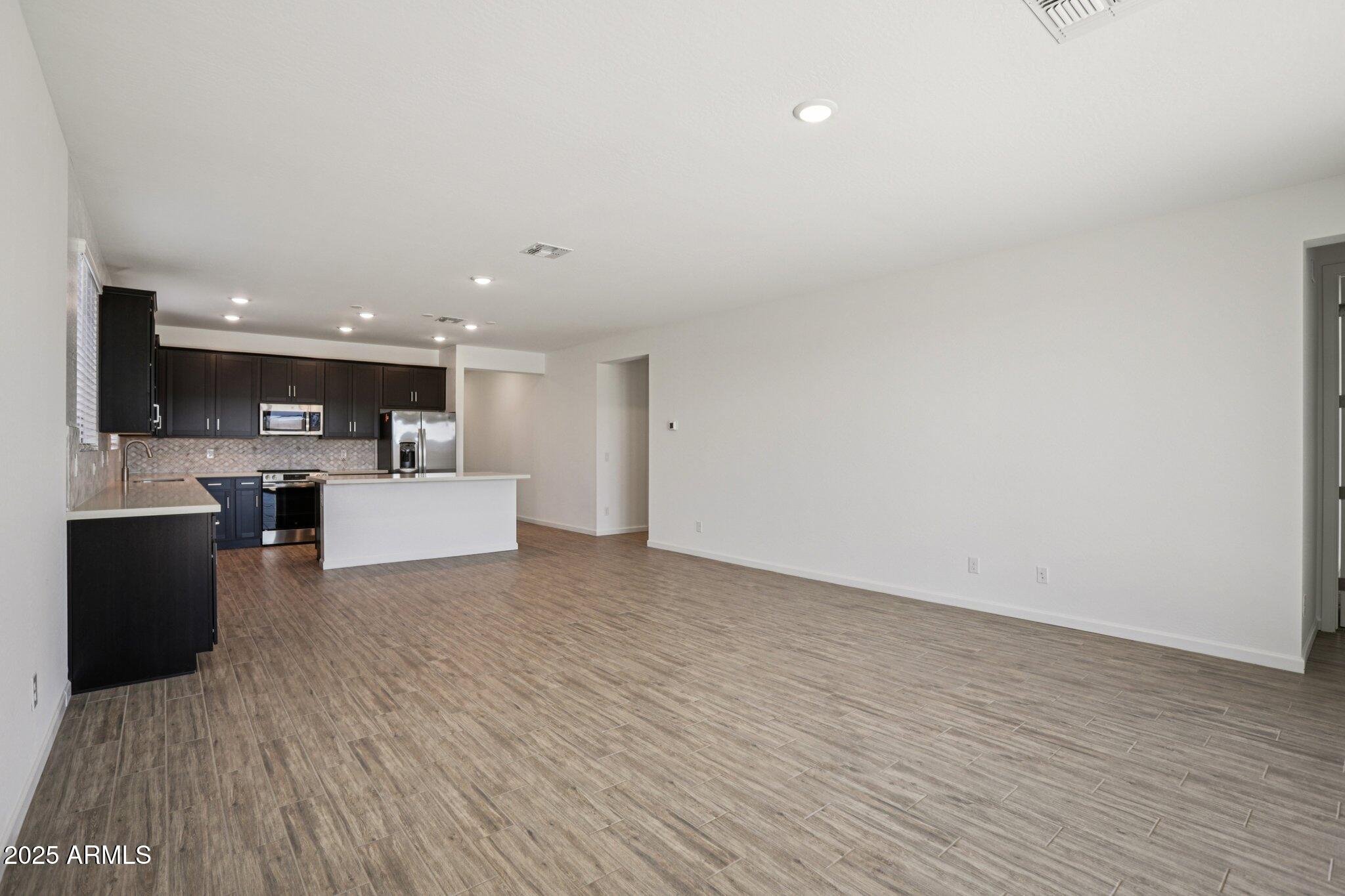 15723 West Brown Street Waddell, AZ 85355 - Photo 4 of 51 a view of a kitchen with a sink and a microwave