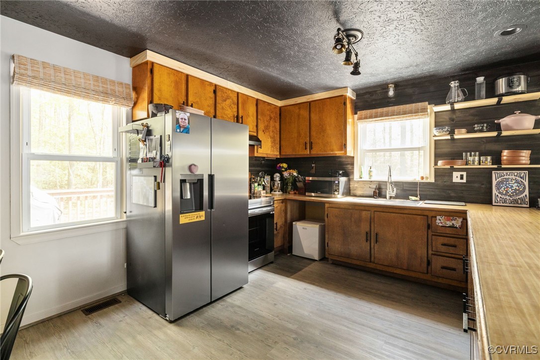 170 Faucetts Road Tappahannock, VA 22560 - Photo 20 of 48 a kitchen with stainless steel appliances granite countertop a refrigerator a sink dishwasher a stove and a microwave oven with cabinets