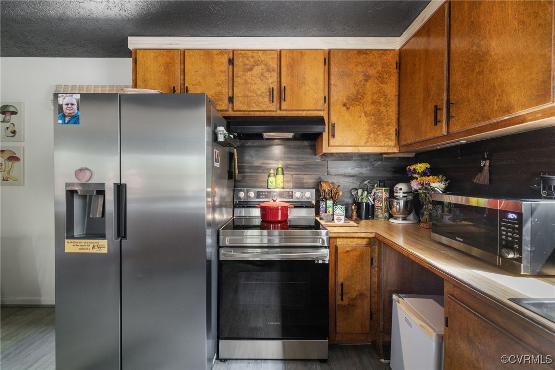 170 Faucetts Road Tappahannock, VA 22560 - Photo 23 of 48 a kitchen with stainless steel appliances granite countertop a refrigerator and a stove