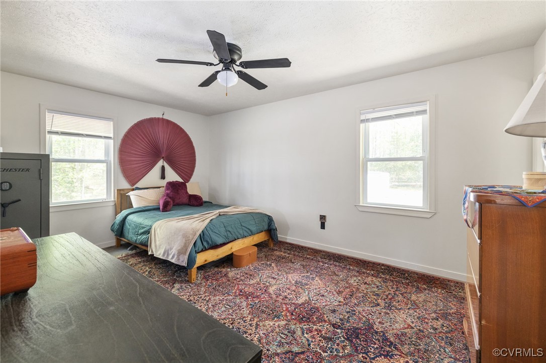 170 Faucetts Road Tappahannock, VA 22560 - Photo 4 of 48 a bedroom with a bed a dresser and a window