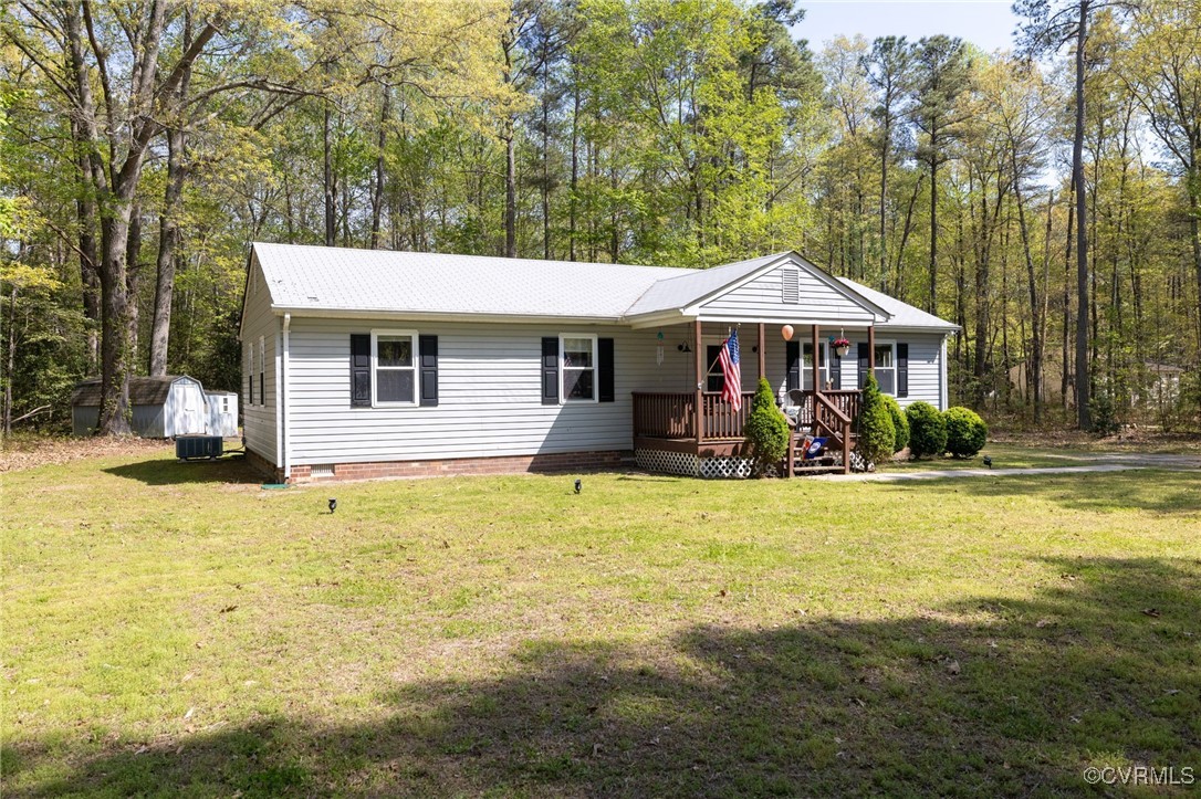 170 Faucetts Road Tappahannock, VA 22560 - Photo 8 of 48 a view of a swimming pool with lawn chairs under an umbrella