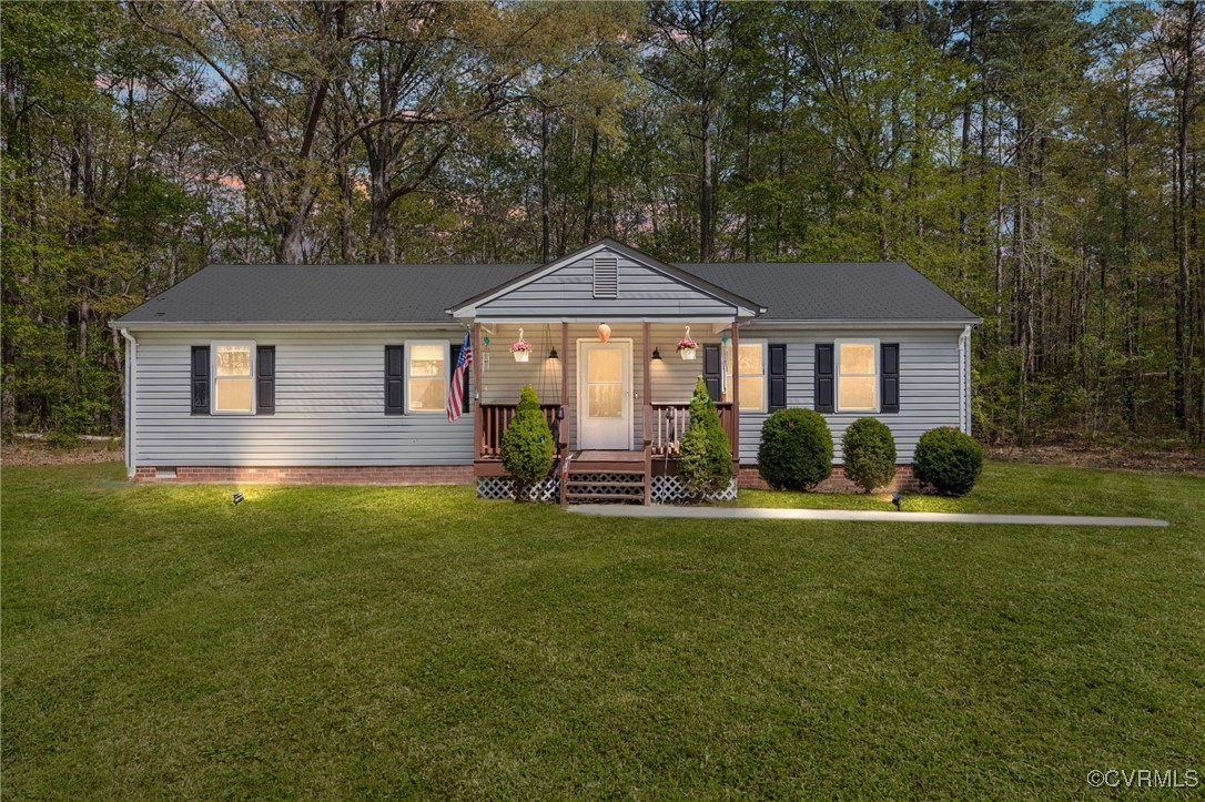 170 Faucetts Road Tappahannock, VA 22560 - Photo 10 of 48 a front view of a house with a yard porch and trees
