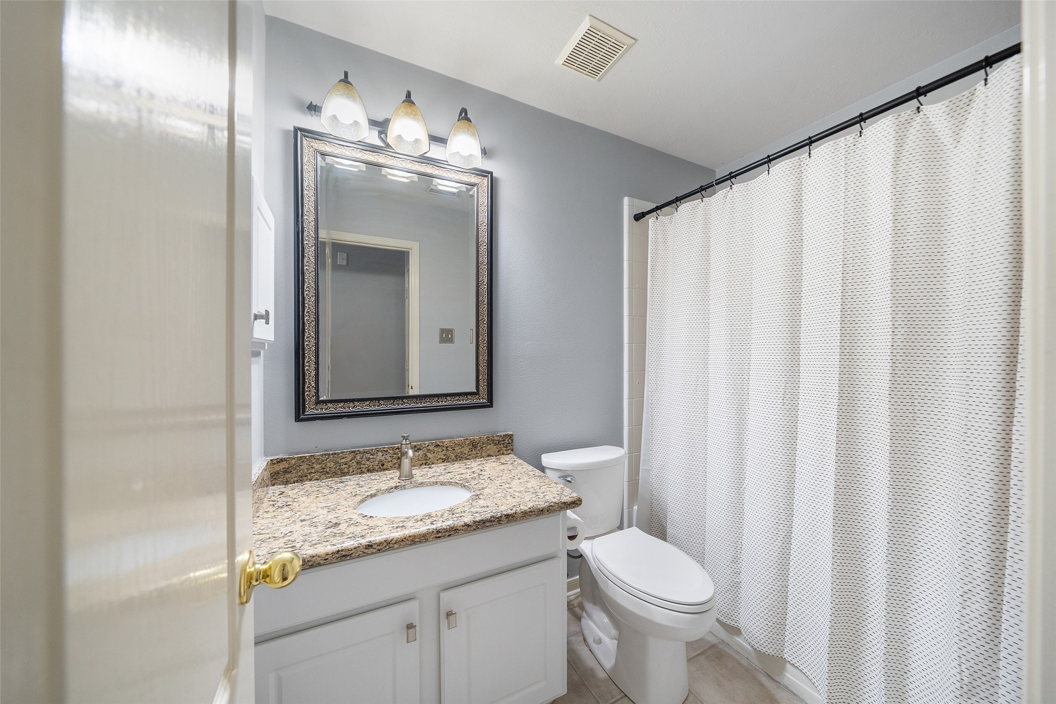 19718 Teller Boulevard Spring, TX 77388 - Photo 28 of 47 a bathroom with a granite countertop sink toilet and mirror