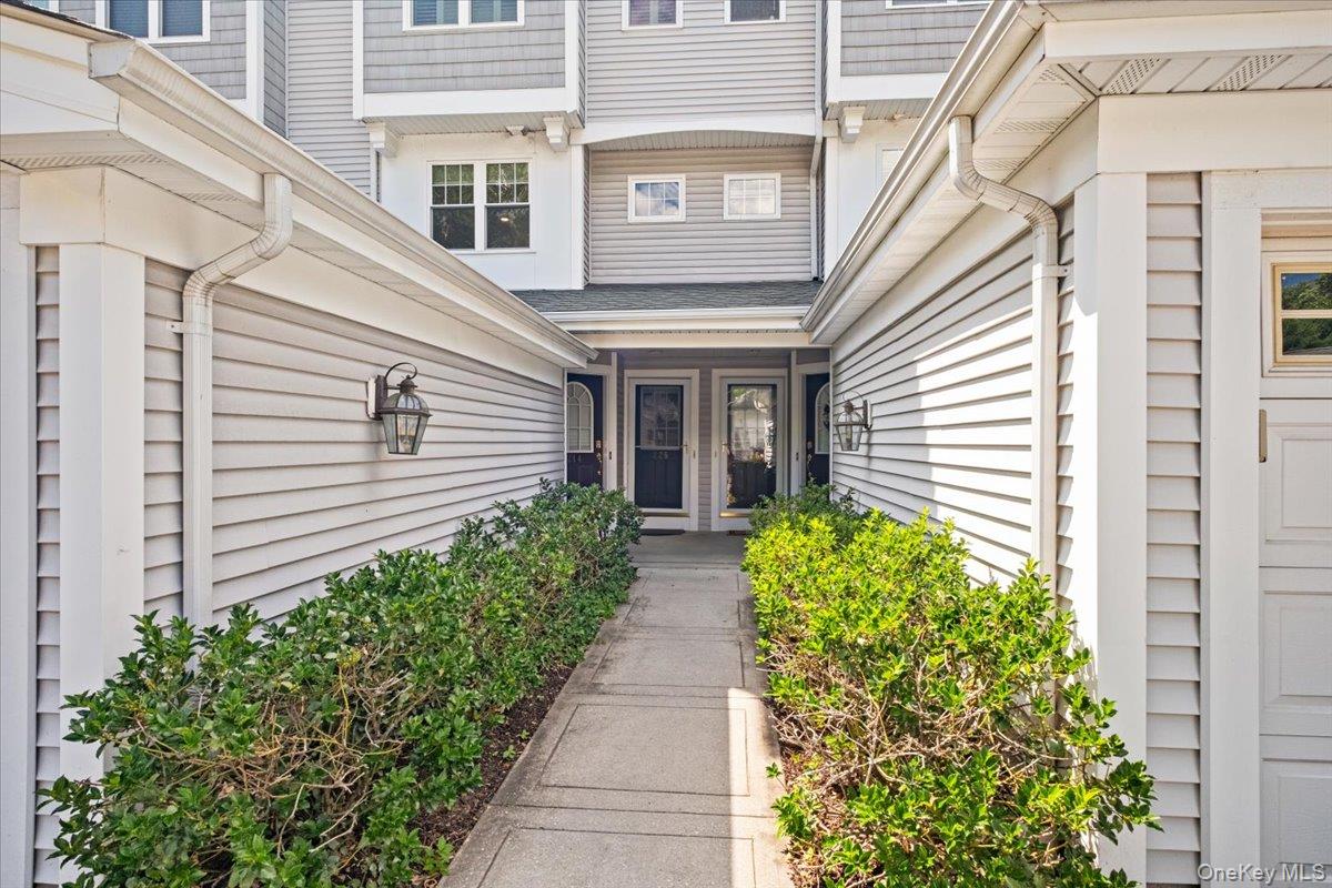 225 Waterside Close Peekskill, NY 10566 - Photo 4 of 40 Walkway flanked by green shrubbery,
