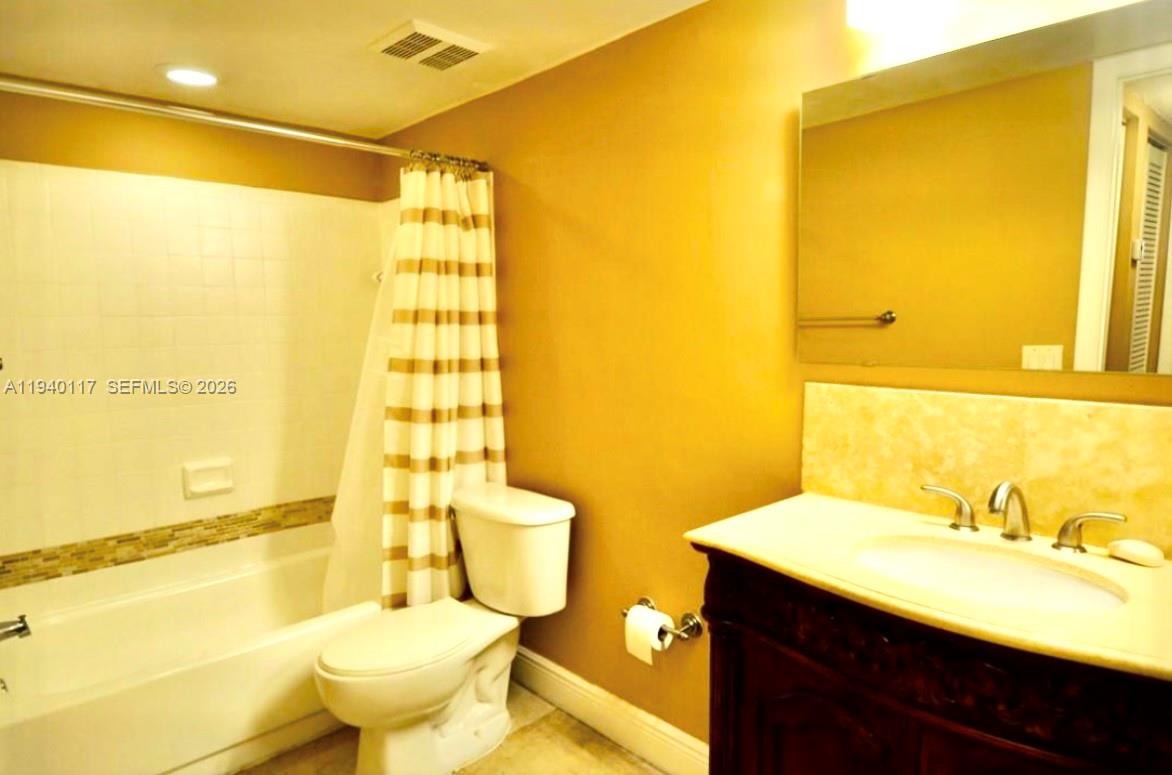 5654 Rock Island Road, Unit 214 Tamarac, FL 33319 - Photo 14 of 26 a bathroom with a sink mirror vanity and toilet