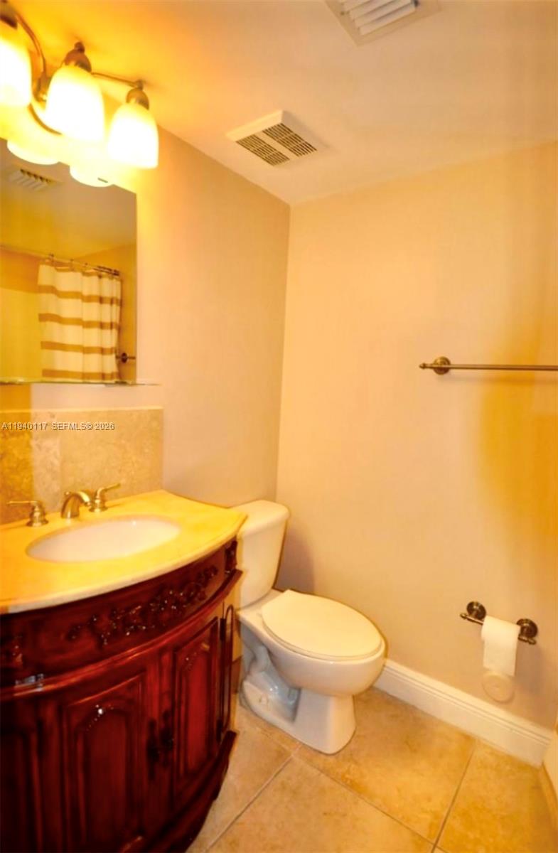 5654 Rock Island Road, Unit 214 Tamarac, FL 33319 - Photo 15 of 26 a bathroom with a granite countertop sink toilet and shower