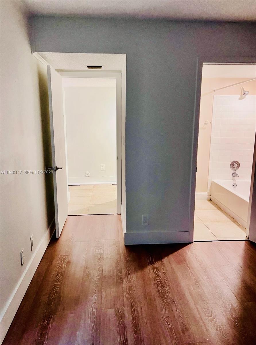 5654 Rock Island Road, Unit 214 Tamarac, FL 33319 - Photo 16 of 26 a view of empty room with wooden floor and door