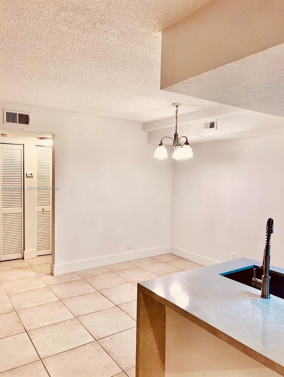 5654 Rock Island Road, Unit 214 Tamarac, FL 33319 - Photo 17 of 26 a view of a kitchen with a sink dishwasher and a refrigerator